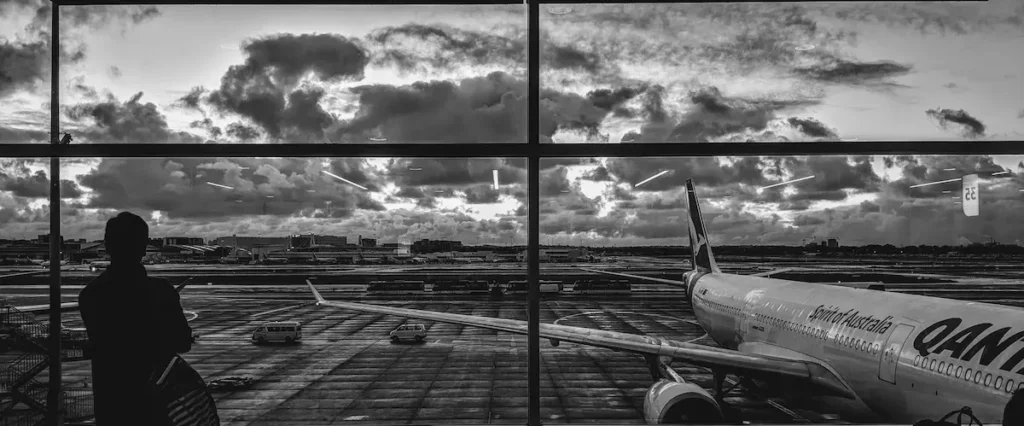 Airplane wing view from Sydney Airport terminal gate