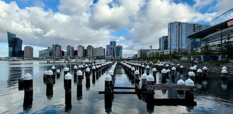Docklands Melbourne harbor promenade with city skyline