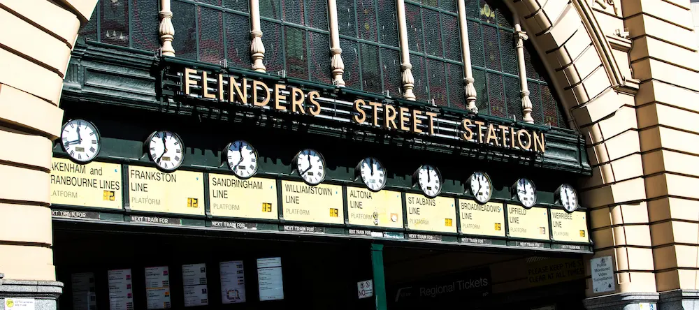 The historic entrance of Flinders Street Station in Melbourne, featuring its iconic yellow facade.